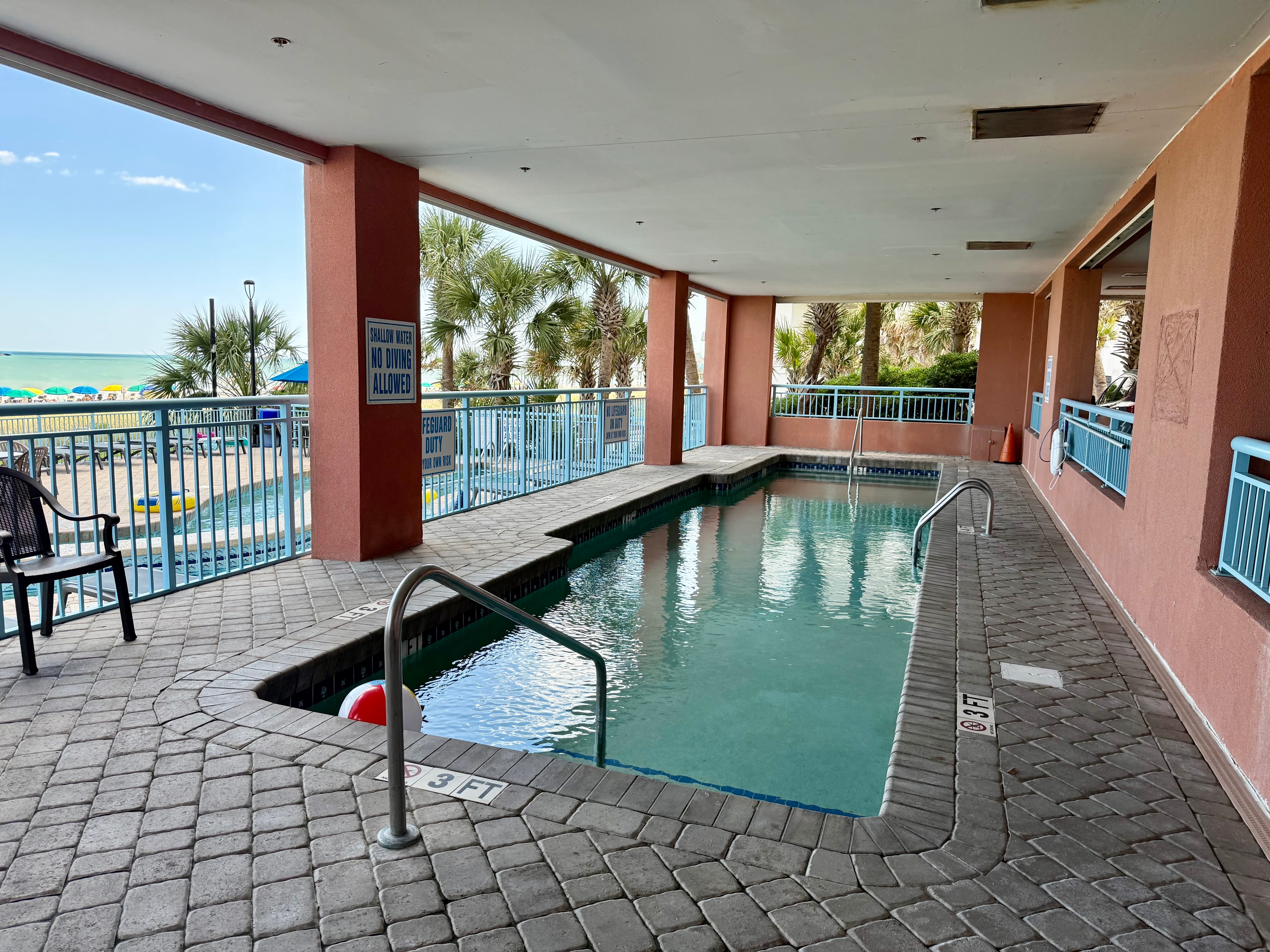 Covered indoor pool with beach view